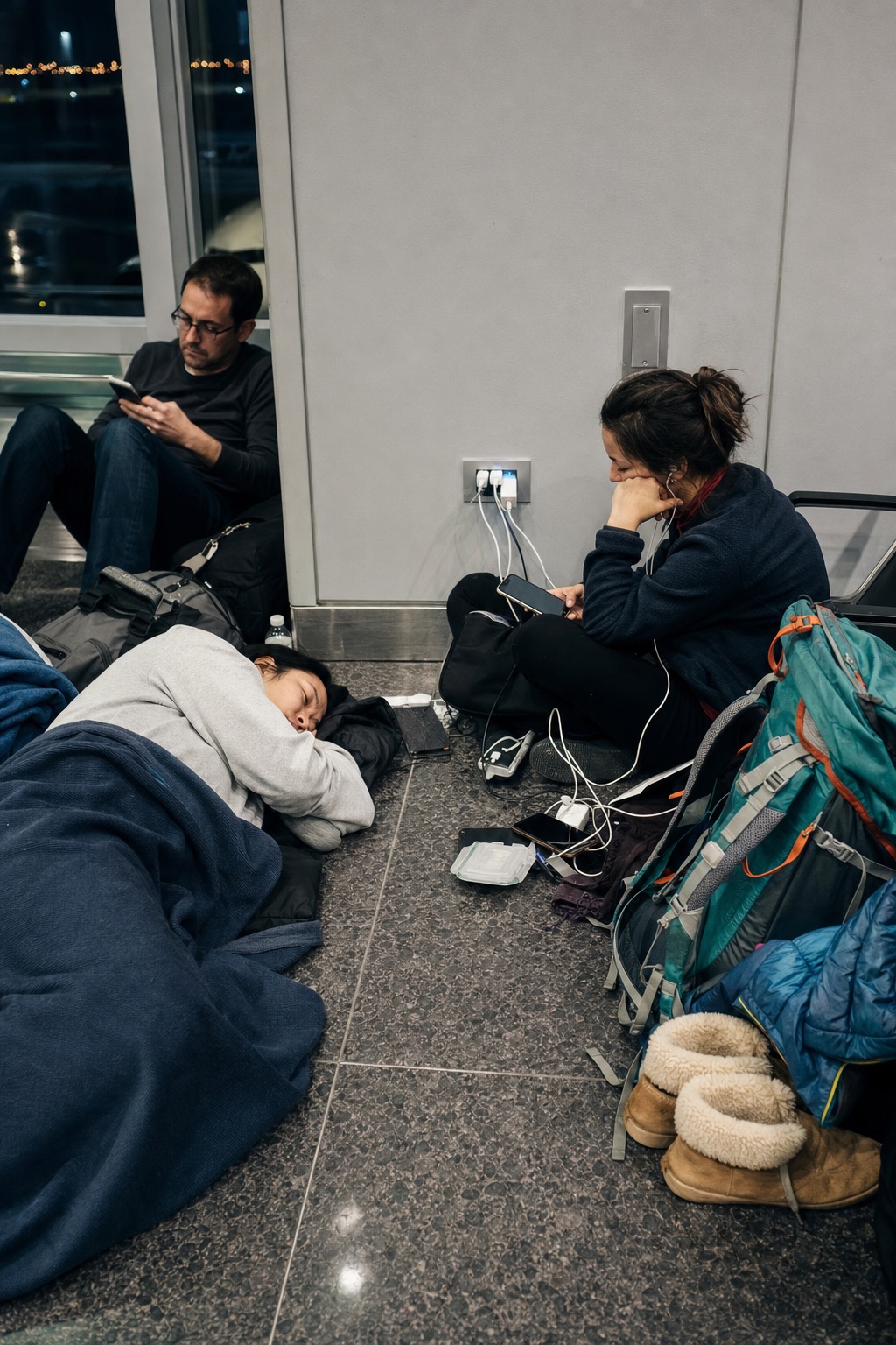 A passenger defends an airport power outlet during the Outlet Possession event